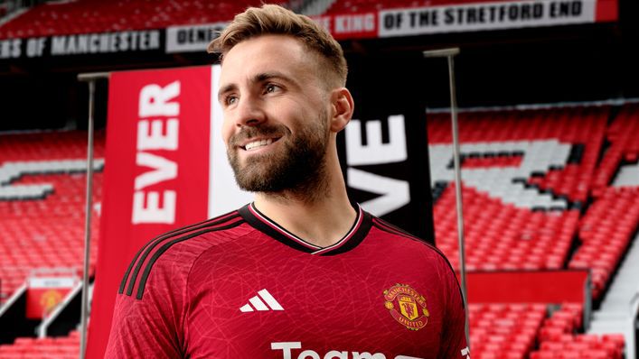 Luke Shaw models Manchester United's 2023-24 home kit